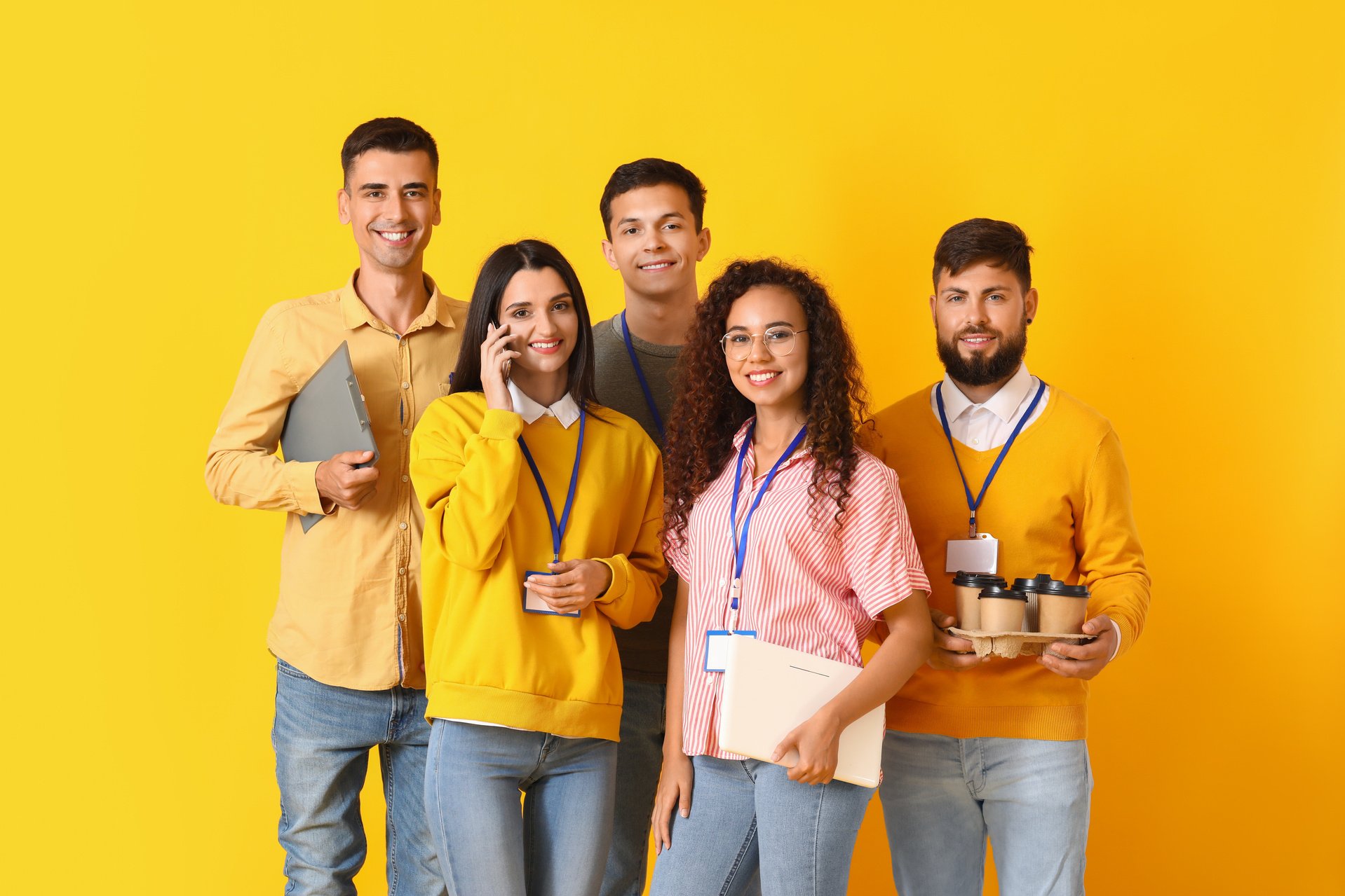 Team of Young Business People on Yellow Background